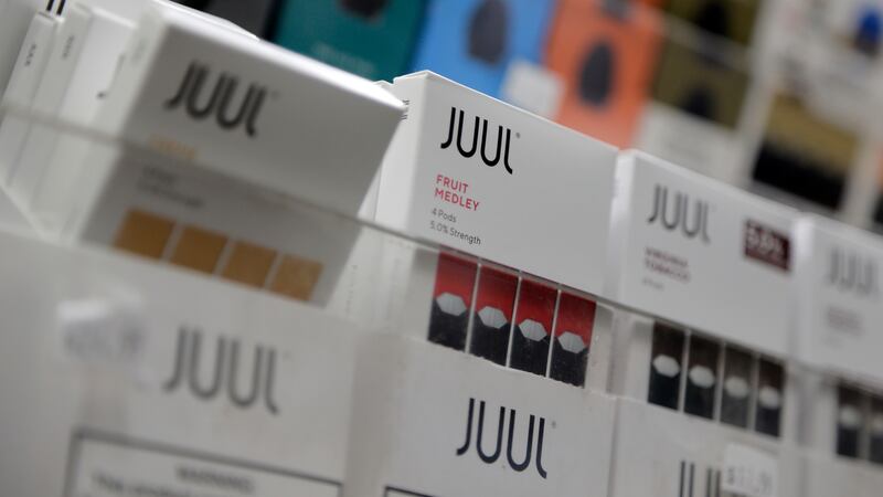 Juul products are displayed at a smoke shop in New York, on Dec. 20, 2018. Embattled vaping...