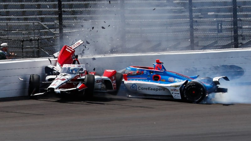 Katherine Legge, of England, left, and Stefan Wilson, of England, crash in the first turn...