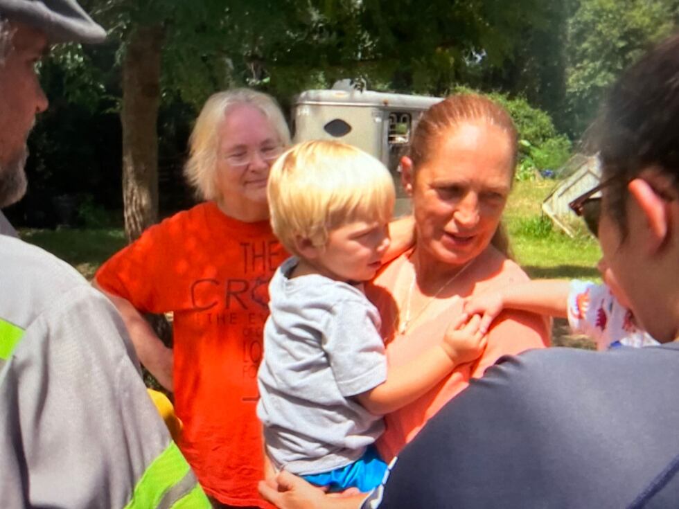 Tammy Bullock holds her three-year-old grandson, who was in the pickup when his older brother...