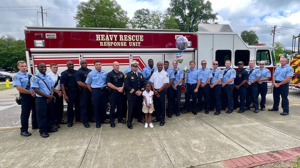 Montgomery firefighters pose for a photo with Dynasti Hartman during her kindergarten honors...