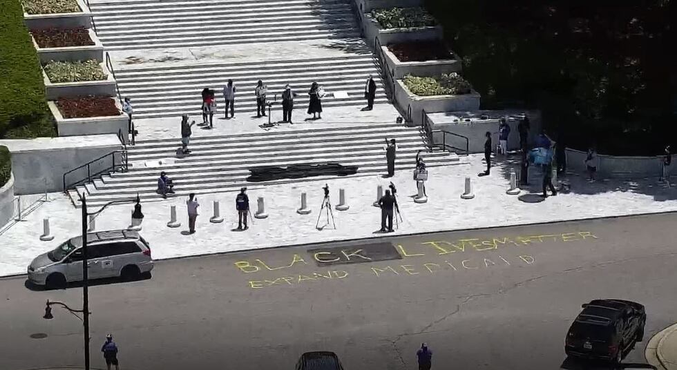 A group that advocates for the expansion of Medicaid in Alabama wrote "Black Lives Matter" in...