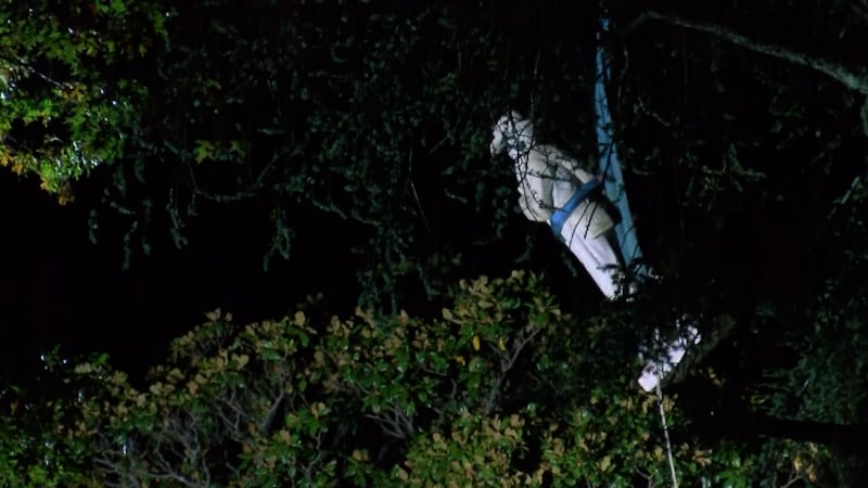 Workers remove the Confederate soldier statue from the Madison County Courthouse