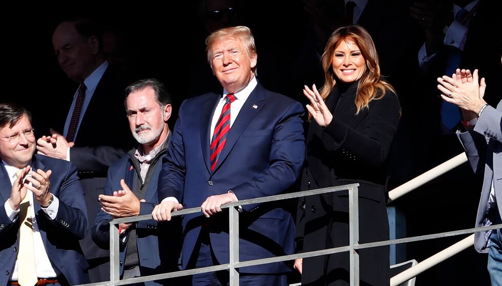 President Donald Trump watches the first half of an NCAA football game between Alabama and LSU...