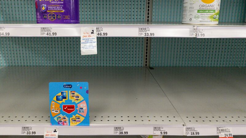 FILE - Baby formula are displayed on the mostly-empty shelves of a grocery store in Carmel,...