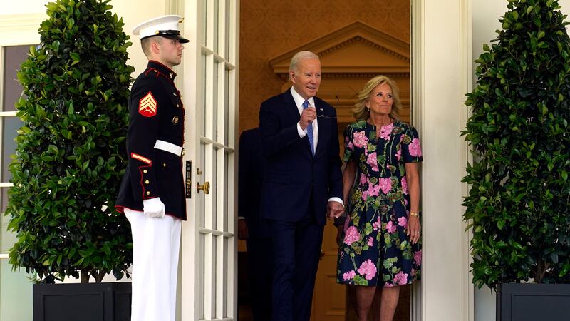 President Joe Biden, accompanied by first lady Jill Biden, walks from the Oval Office to...