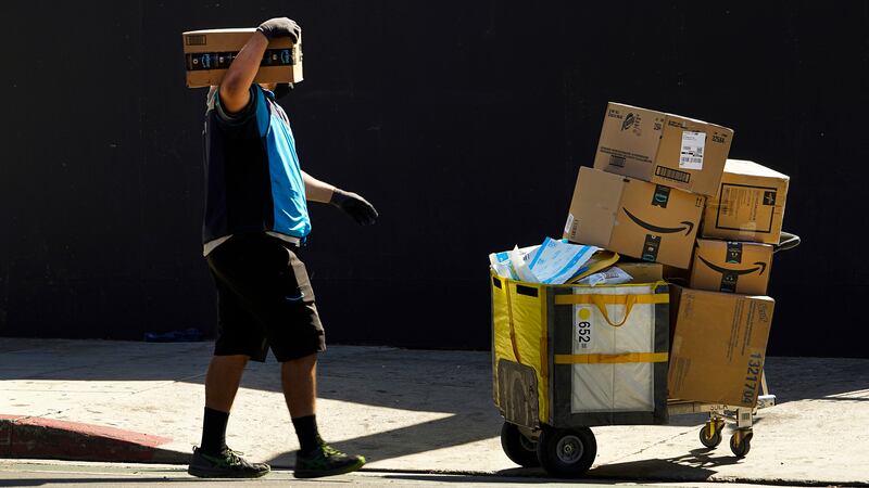 FILE - An Amazon worker delivers boxes in Los Angeles on Oct. 1, 2020. Amazon said Wednesday,...