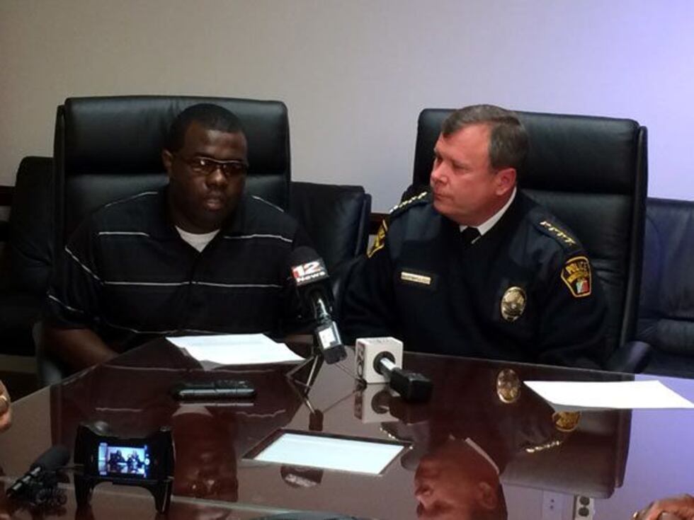 Officer Carlos Rogers (L) and Police Chief Kevin Murphy (R) at a news conference Thursday to...