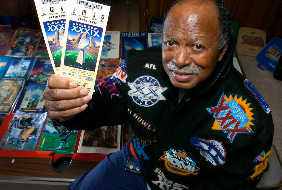 FILE — Gregory Eaton shows his tickets for the 2005 Super Bowl while seated among many other...